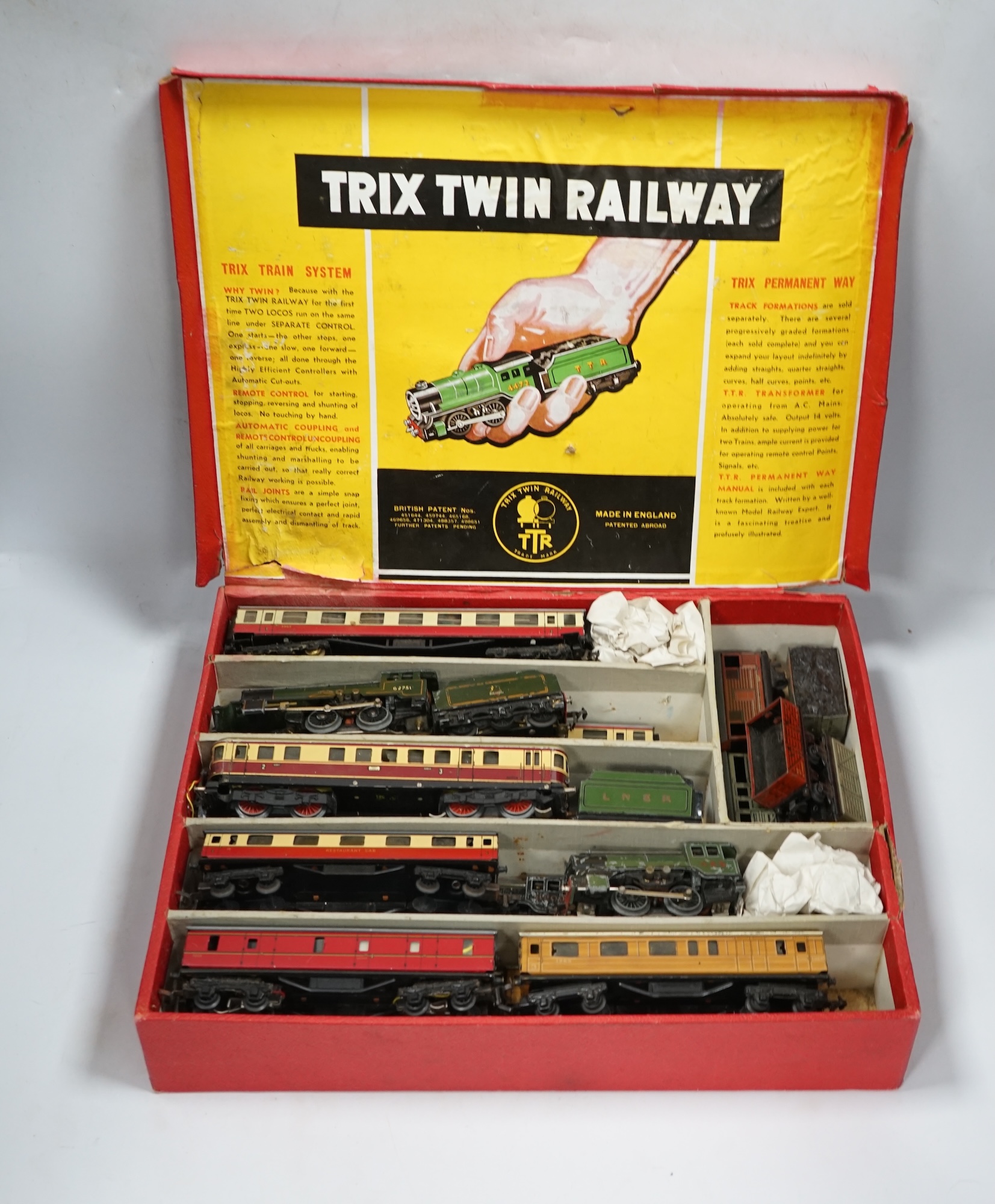 A Trix Twin Railway 00 gauge train set box containing; four locomotives, eight bogie coaches, two railcars, and six freight wagons, together with a live steam Marklin 0-4-0T LNER locomotive. Condition - poor to fair.